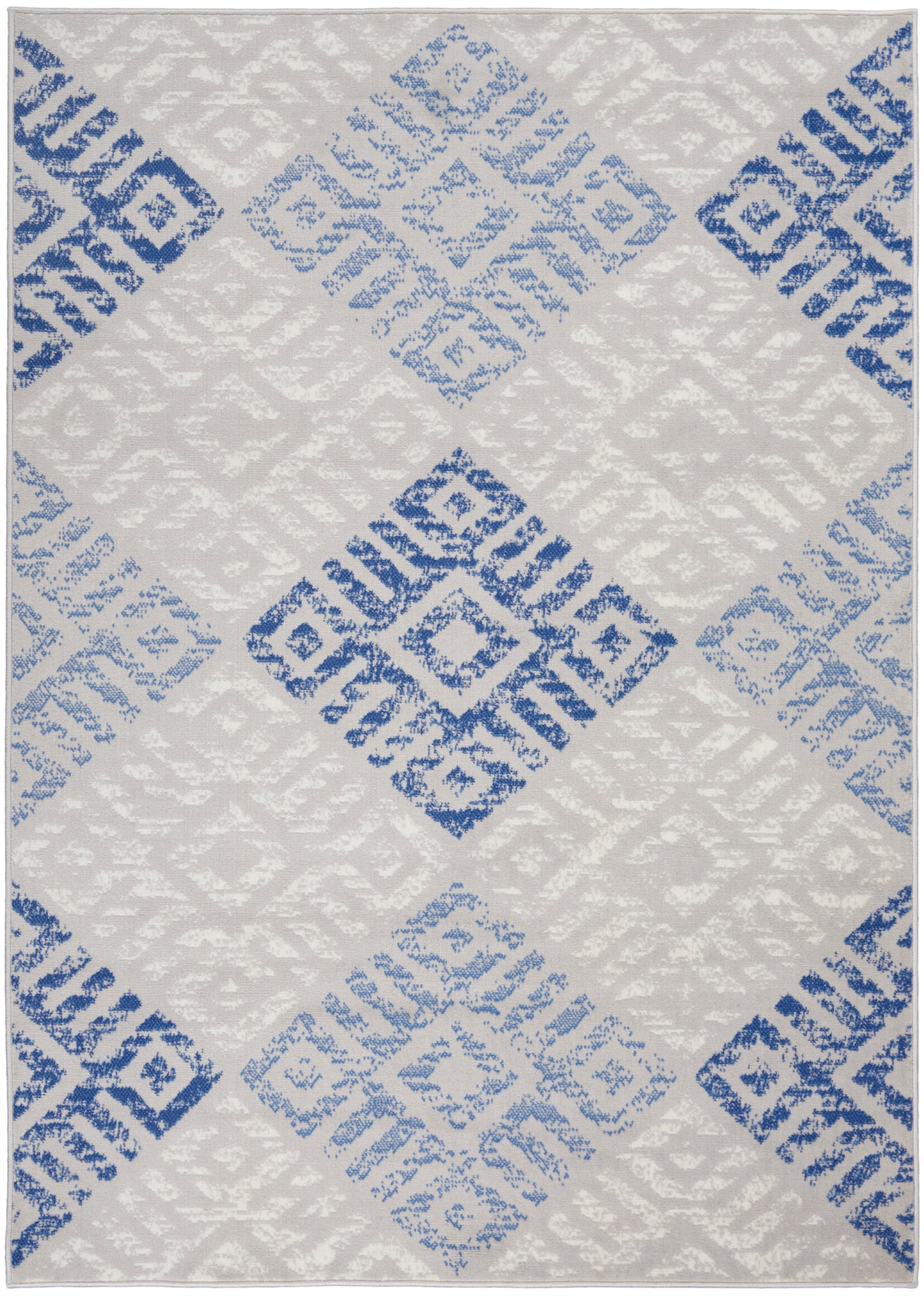 Light gray rug with blue diamond blocks in a modern distressed geometric pattern; soft textured weave.