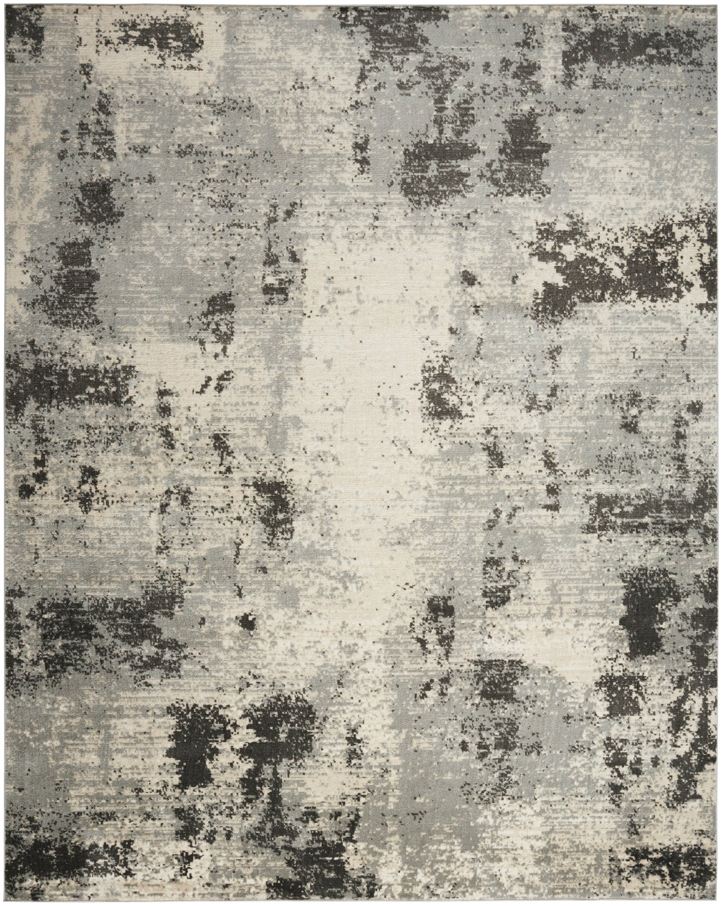 Abstract distressed area rug in gray, beige and charcoal with darker patches; modern, neutral decor.