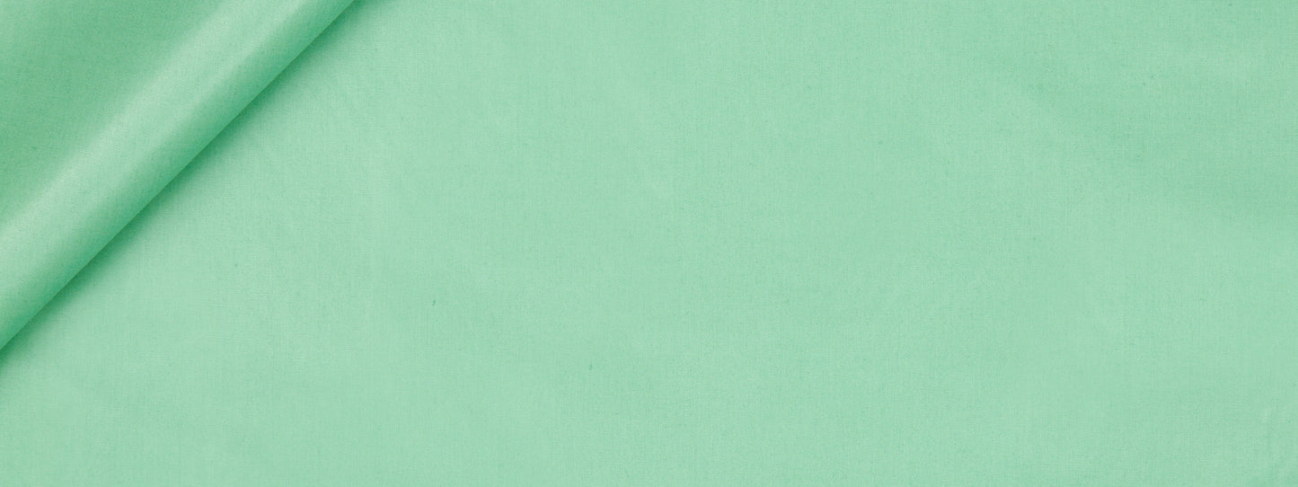 Mint green fabric roll on a solid green background; smooth textile ideal for sewing or crafts.