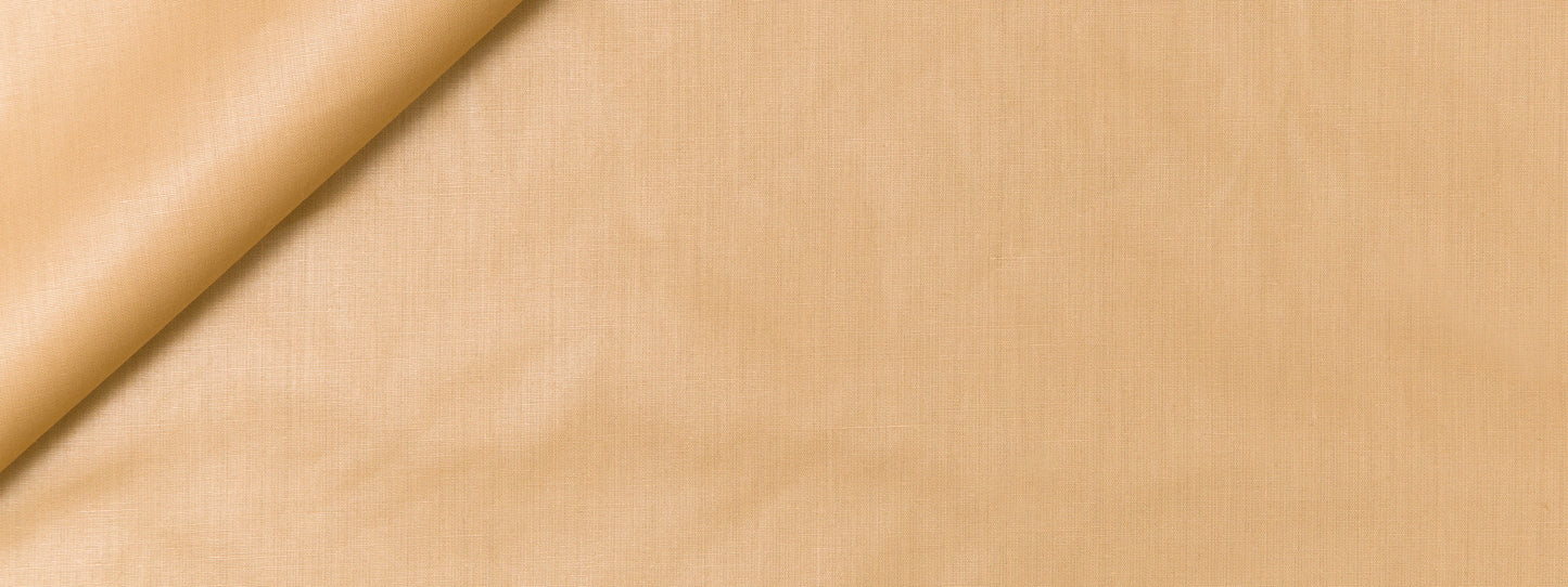 Beige fabric close-up with a soft fold, smooth linen/cotton texture, warm tan color for apparel or upholstery.