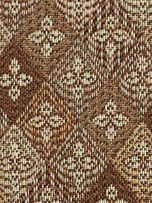Brown and beige diamond lattice tweed fabric with small floral motifs; textured woven textile.