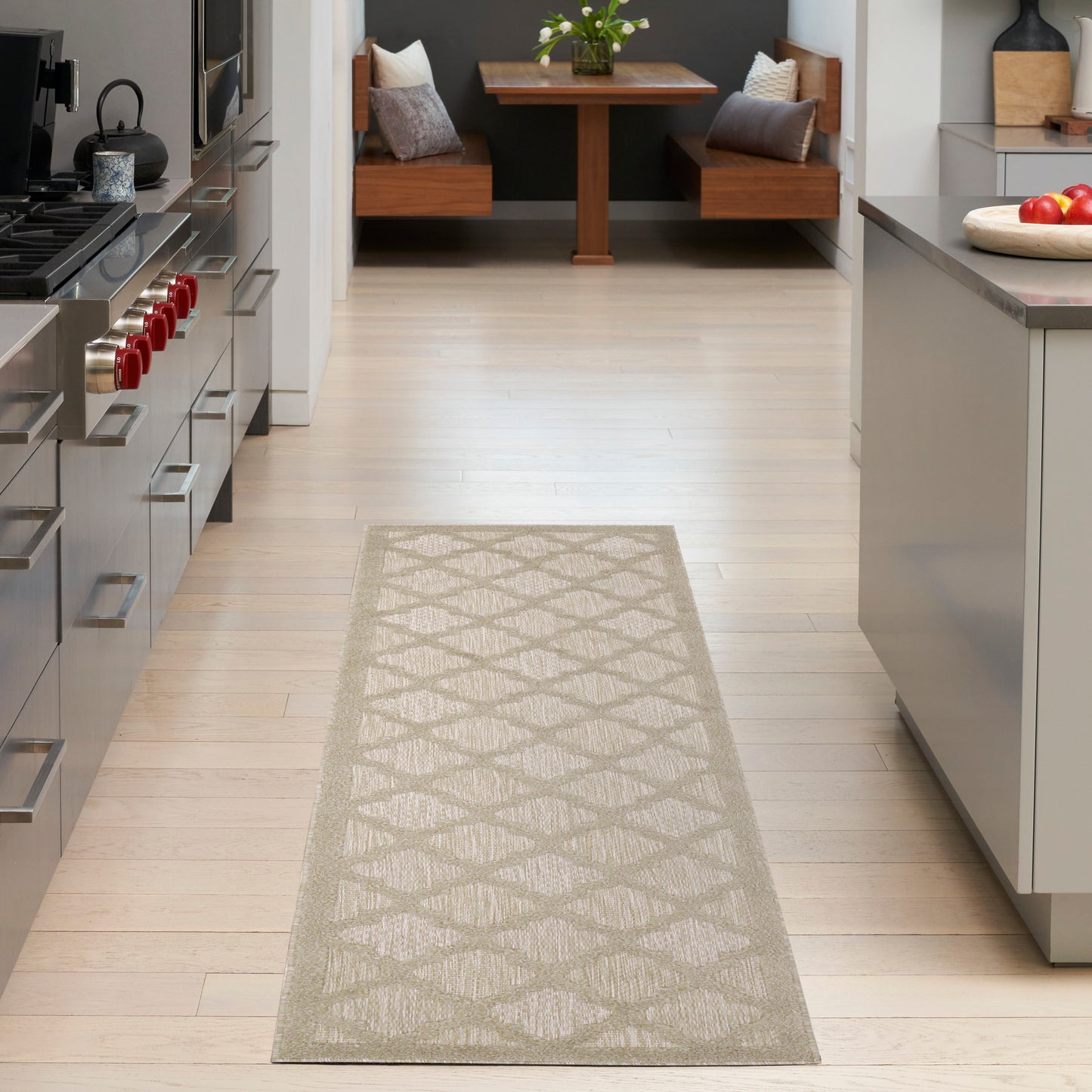 Beige woven rug runner with a diamond lattice pattern on a light wood kitchen floor, guiding to a dining nook.