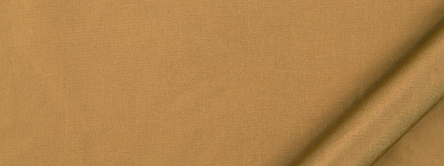 Aged bronze fabric close-up with a soft woven texture and rolled edge.