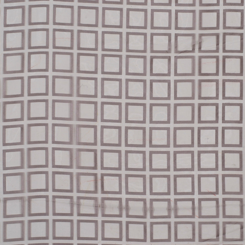 Soft pink background with a repeating brown square grid; geometric square-block pattern on drapery fabric.