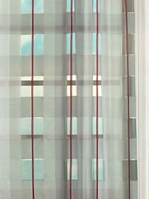 Sheer ruby curtain with burgundy vertical stripes, lightweight fabric for soft daylight in modern window decor.