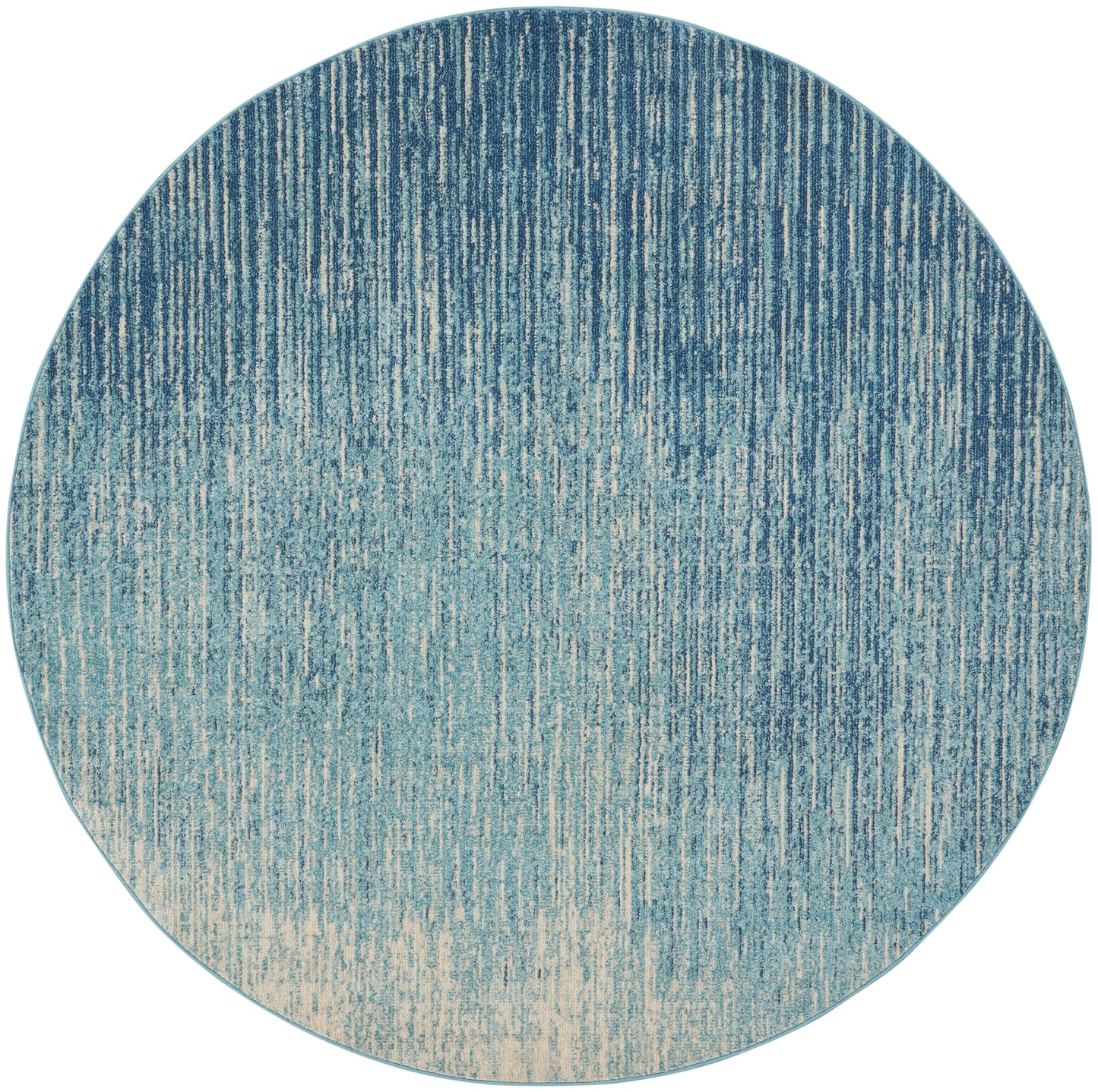 Round rug with blue gradient and vertical stripe texture, navy to beige ombre.