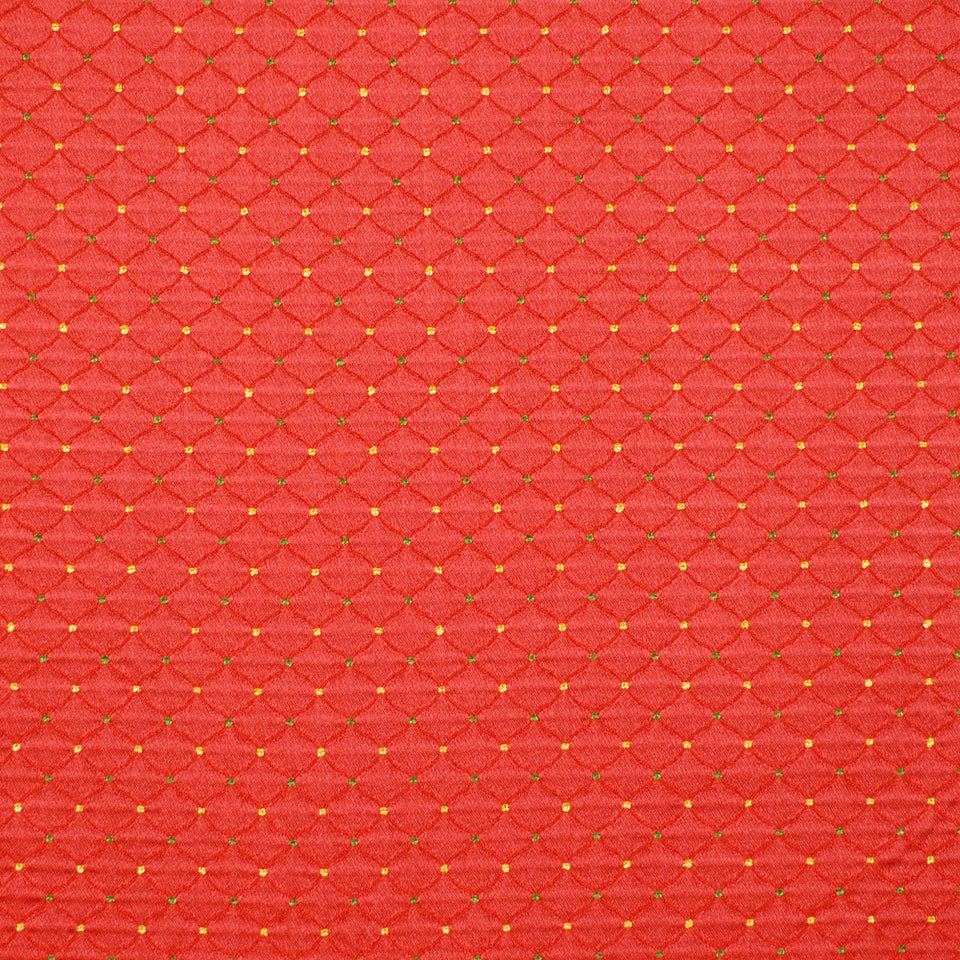 Crimson diamond-quilted upholstery fabric with a textured pattern and gold stitching.