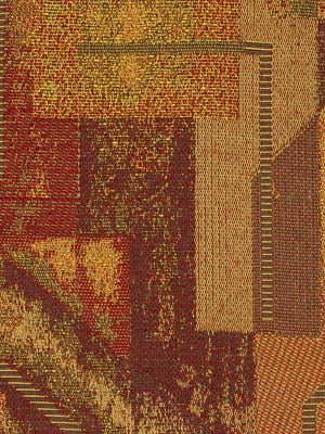 Warm-toned woven upholstery fabric with abstract patchwork blocks in amber, orange, brown and tan hues.