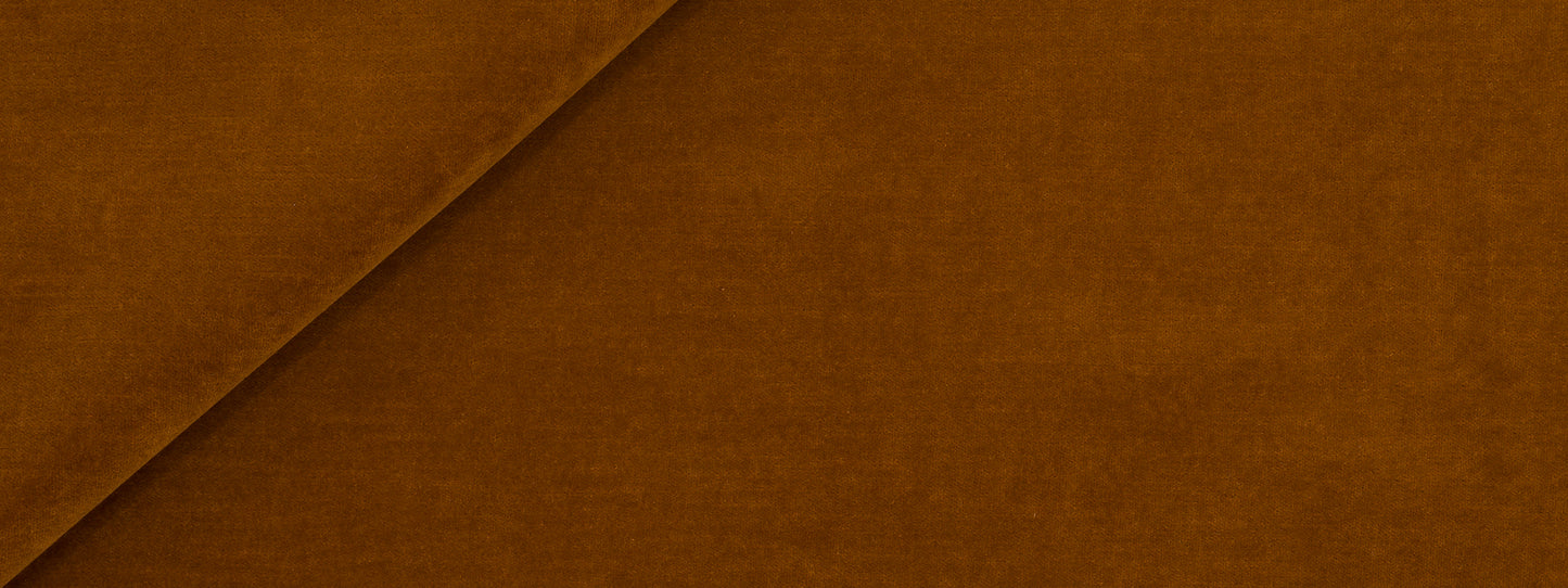 Warm brown suede-like fabric with a diagonal seam, close-up texture.