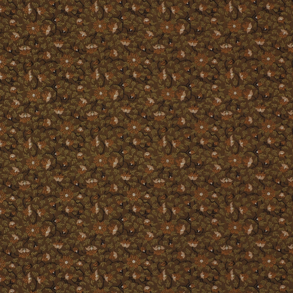 Brown leafy floral upholstery fabric pattern with beige accents; repeating motif.