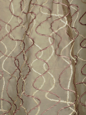 Beige curtain fabric with white and pink wavy line embroidery creating a spiraling pattern; lightweight drapery.