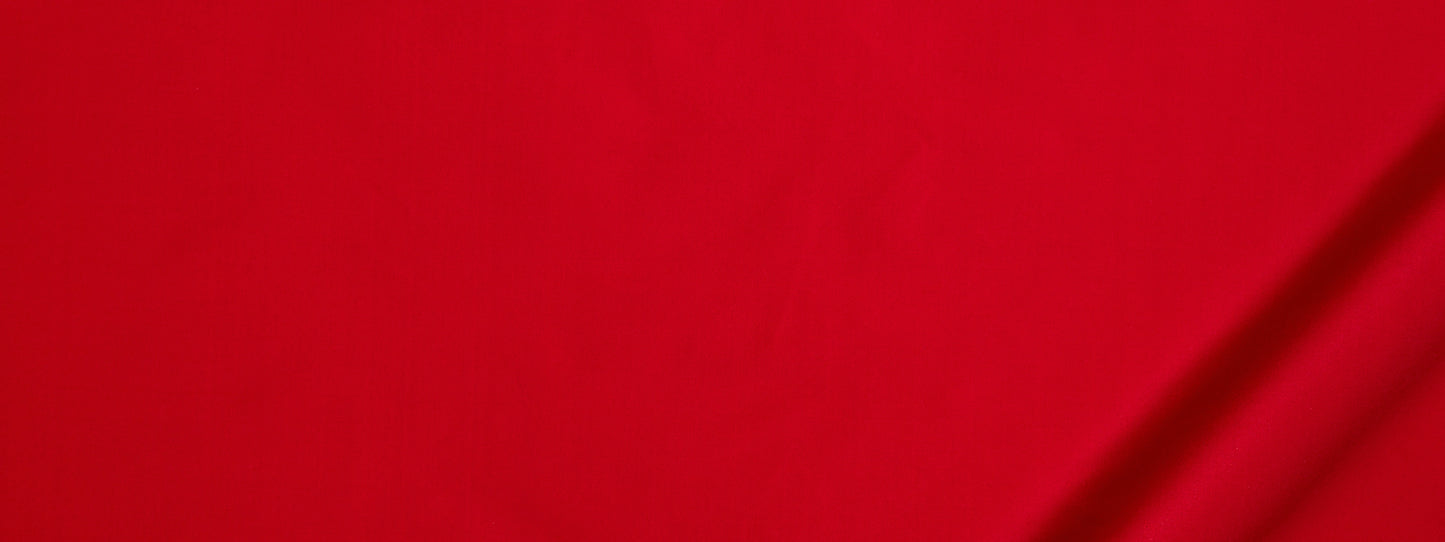 Bright red fabric with subtle diagonal lines and right-edge shadows, smooth and bold.