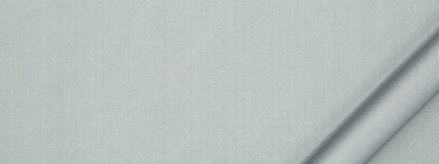 Soft light blue fabric with subtle vertical weave and a diagonal fold along the right edge.