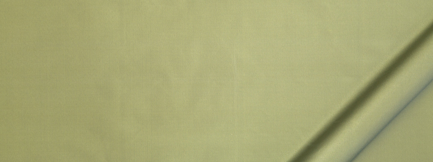 Olive-yellow fabric close-up with a diagonal crease, soft textile texture for clothing or home decor.