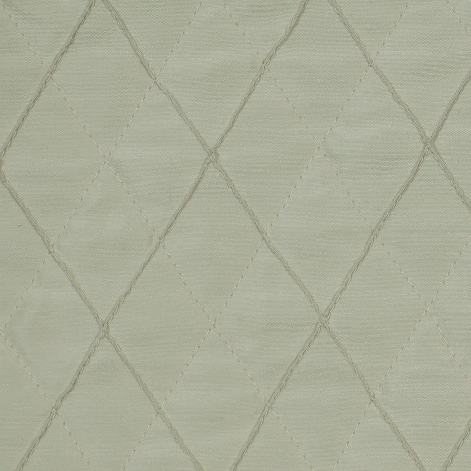 Light beige-gray quilted fabric with a diamond stitching pattern; plush upholstery or bedding material.