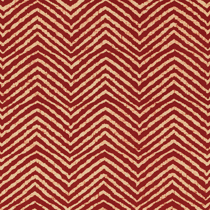 Red & cream chevron zigzag pattern on textile; bold rug or throw fabric.