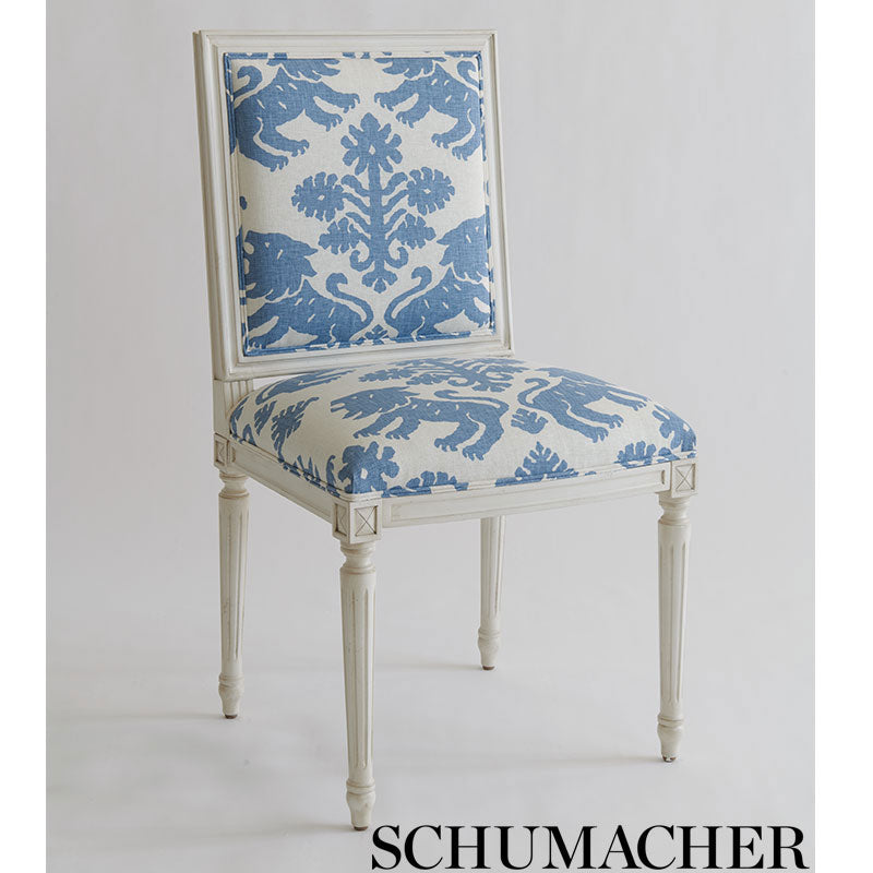 Blue damask print on cream background; ornate textile pattern.