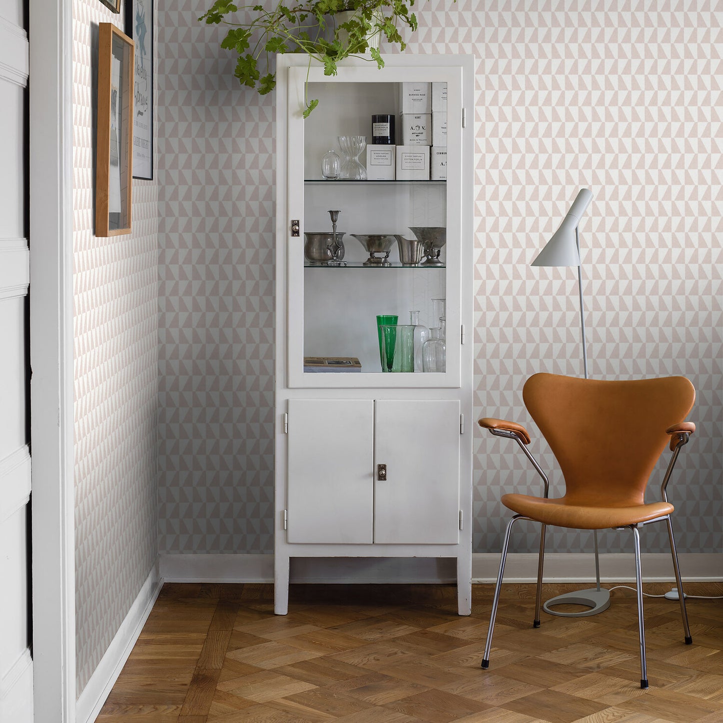 Geometric wallpaper with a trapezoid-petal motif; white and pale tones.