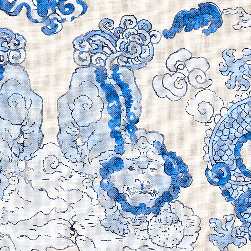 Blue and light-blue dragon and cloud motif on porcelain surface; decorative dragon print.