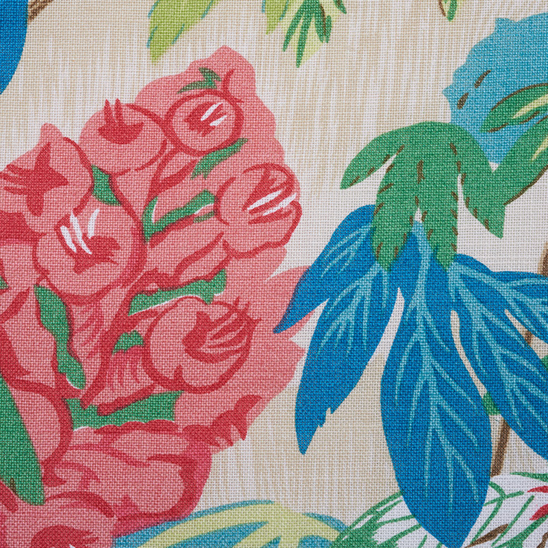 Coral fabric with a vibrant floral print: pink roses clustered with green stems and bold blue tropical leaves.