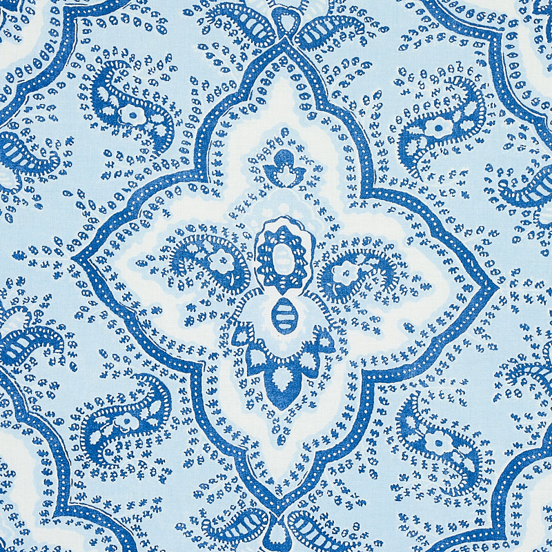 Blue and white damask print on fabric with ornate quatrefoil medallions and scrolling floral motifs.
