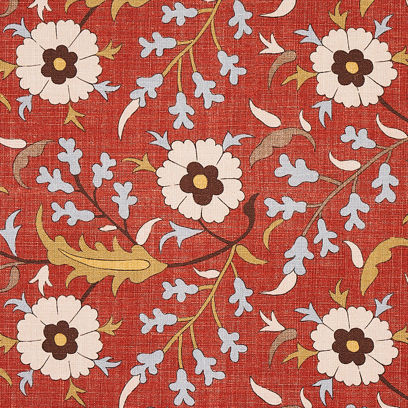 Red fabric with large white flowers, brown centers, pale blue blossoms, and olive-green vines in a botanical print.