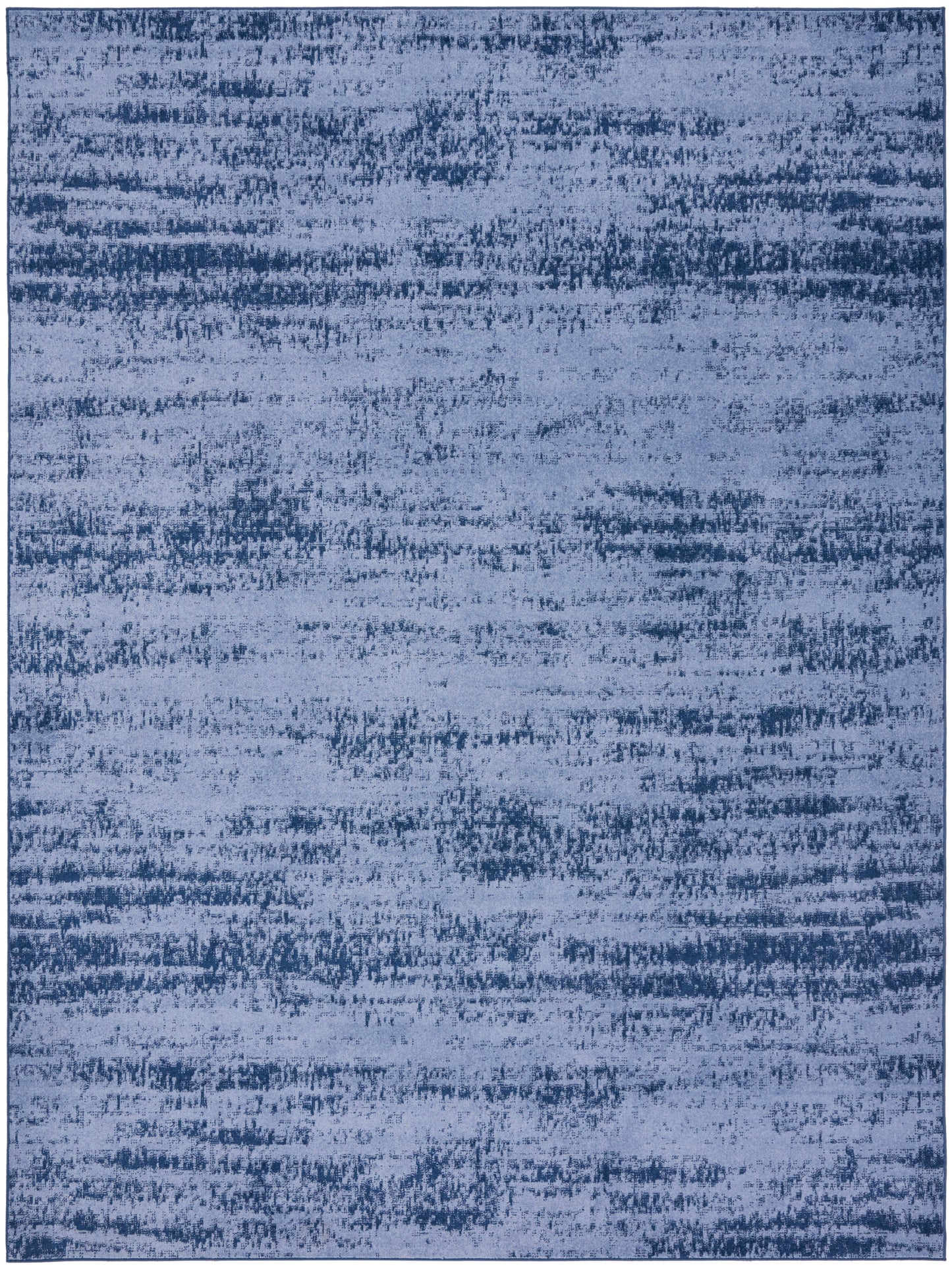 Rectangular blue area rug with an abstract distressed pattern in indigo and denim tones; soft, modern vibe.