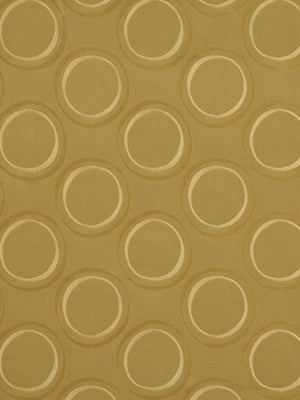 Gold circular ring pattern on tan upholstery fabric; embossed, geometric texture.
