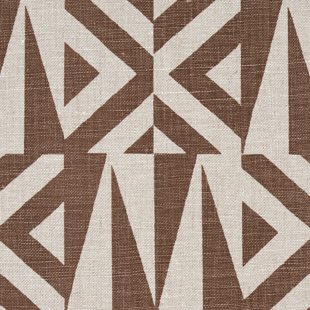 Brown and cream woven fabric with interlocking triangles and diamond shapes in a bold geometric tribal pattern.