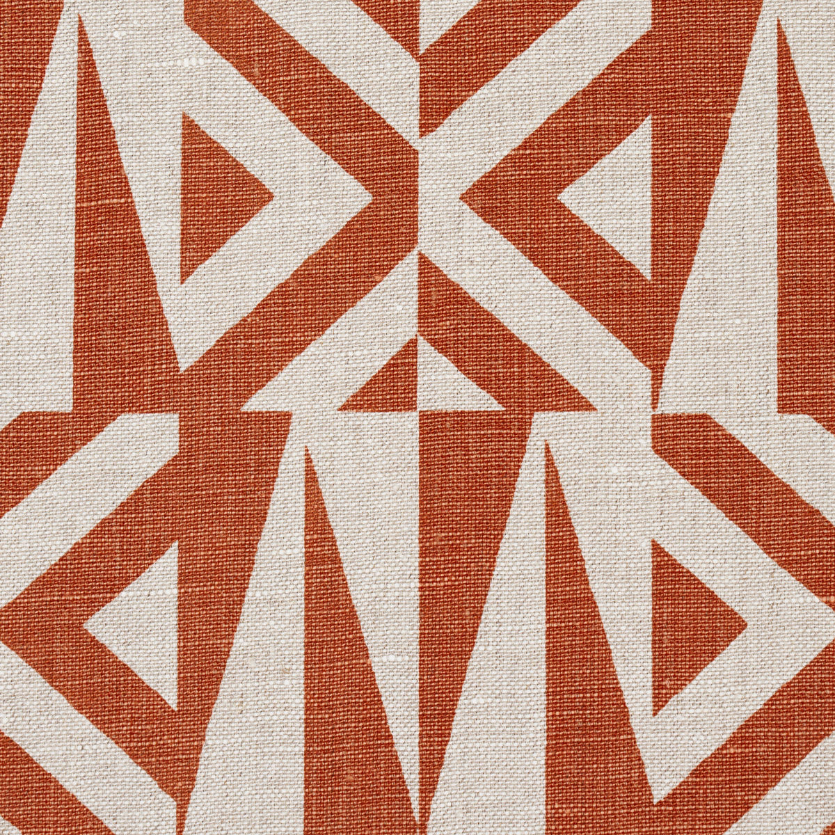 Orange and cream geometric woven rug with triangles and chevrons; textured textile.