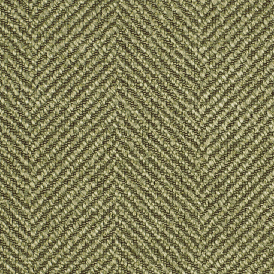 Olive-green and beige herringbone tweed upholstery fabric with a chevron pattern; textured woven material.