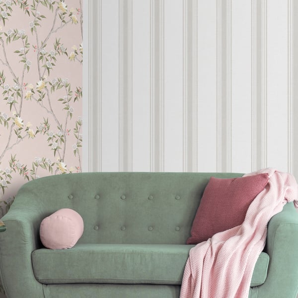 Beige wallpaper with pink floral pattern on a wall beside white paneling.