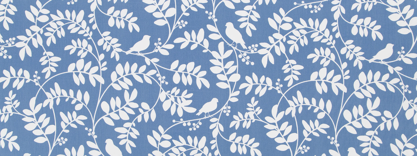 Blue drapery fabric with white botanical leaves and small birds in a repeating pattern.