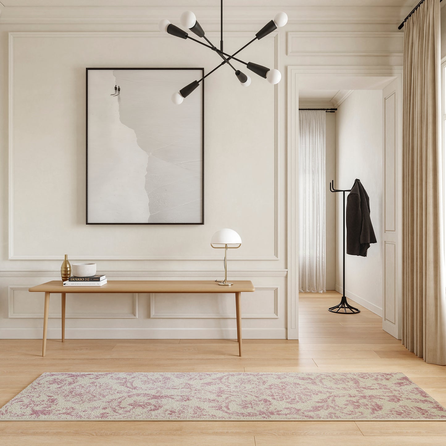 Minimalist entryway with light-wood console, black-framed abstract art, pale pink runner rug, modern chandelier, coat rack.