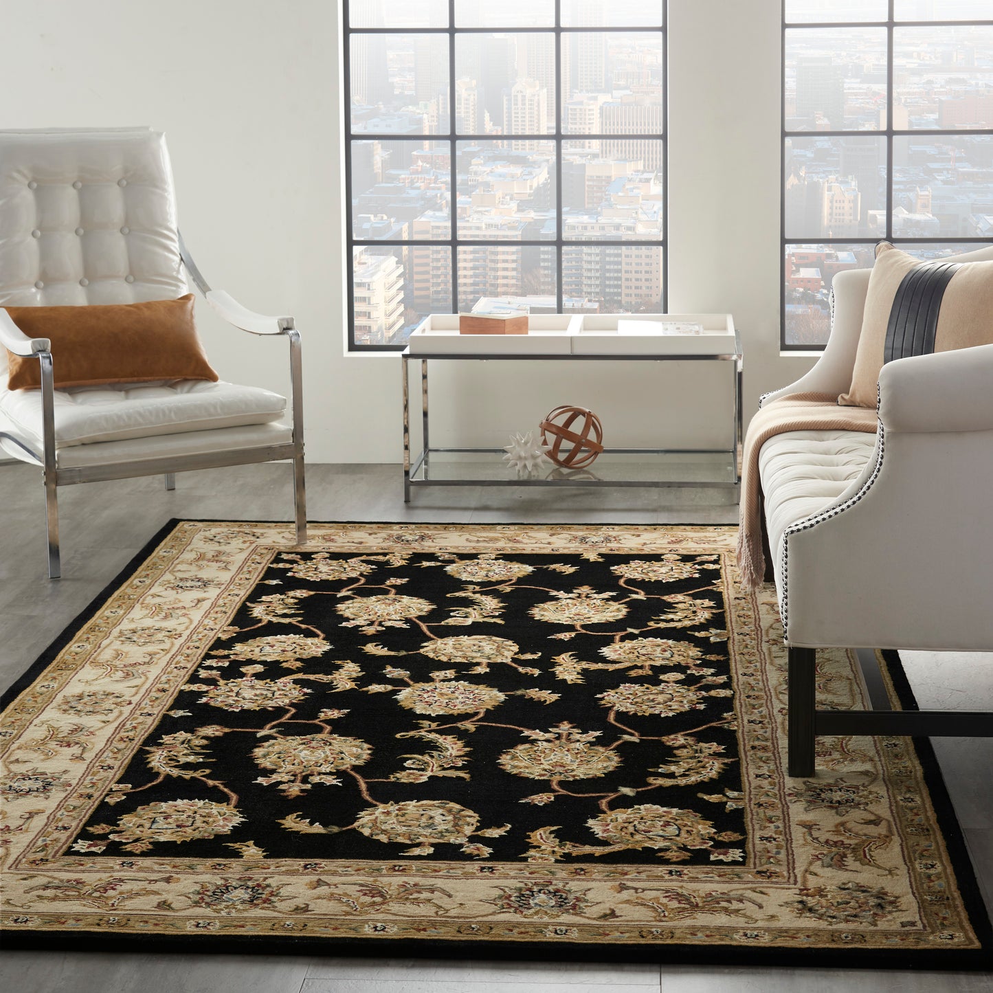 Black rectangular oriental area rug with beige & gold floral motifs and a pale beige border.