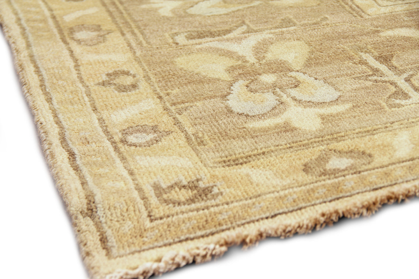 Beige oriental rug with cream floral border, tan accents, plush pile and fringed edge.