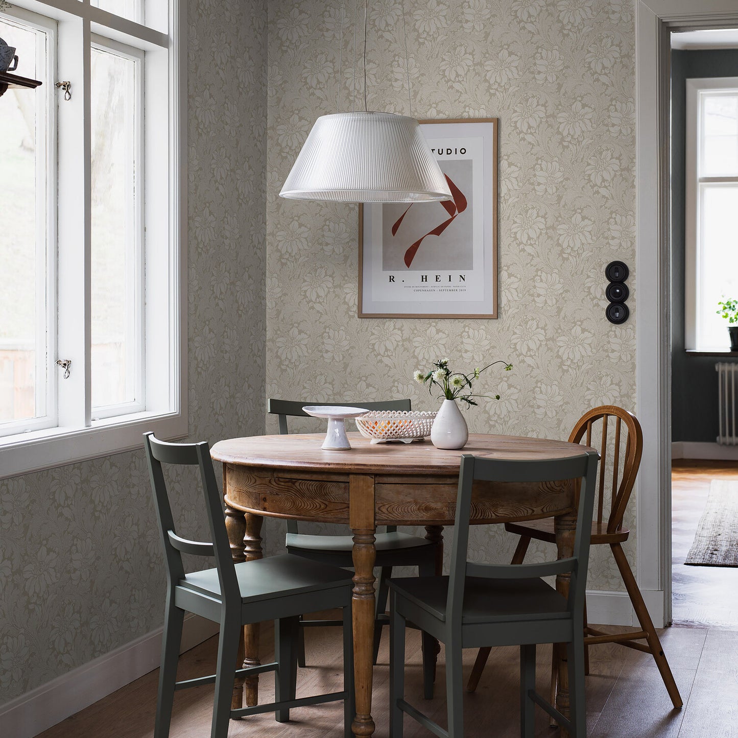 Floral wallpaper with an acanthus leaf pattern in a stone color.