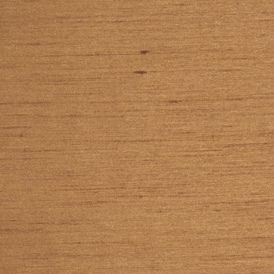 Close-up of copper-toned fabric with a subtle weave and soft texture.