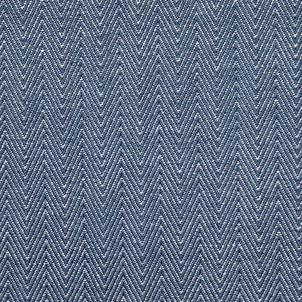Blue denim-like chevron weave upholstery fabric with white speckles, repeating zigzag pattern.