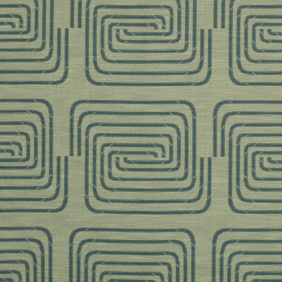 Indigo fabric with a teal nested square spiral pattern in a repeating retro geometric upholstery textile.