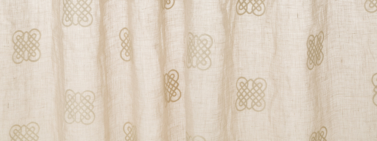 Cream curtain fabric with tan interlocking knot motifs; soft drape for window decor.