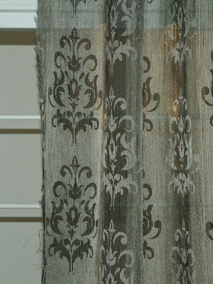 Grey sheer curtain with vertical damask motifs in darker grey, linen-textured fabric, decorative window drape.