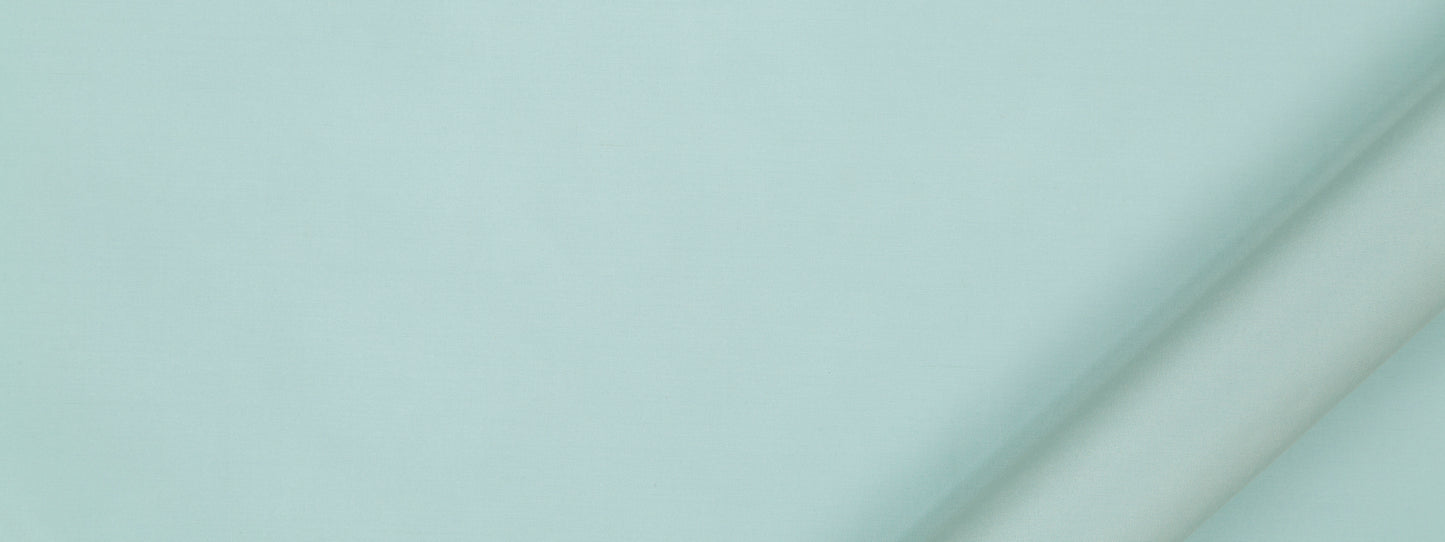 Mint teal fabric with a diagonal rolled edge on the right, smooth matte surface for sewing or crafts.