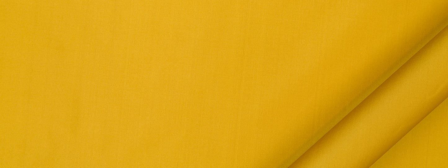 Bright yellow fabric close-up with folded corner and diagonal shadows, versatile for clothing or home decor.