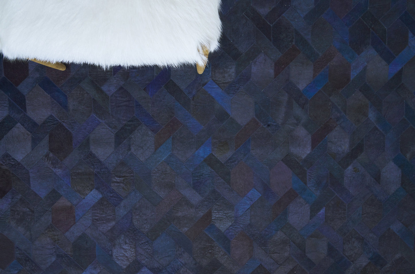 Natural hide indoor hand-stitched rug.