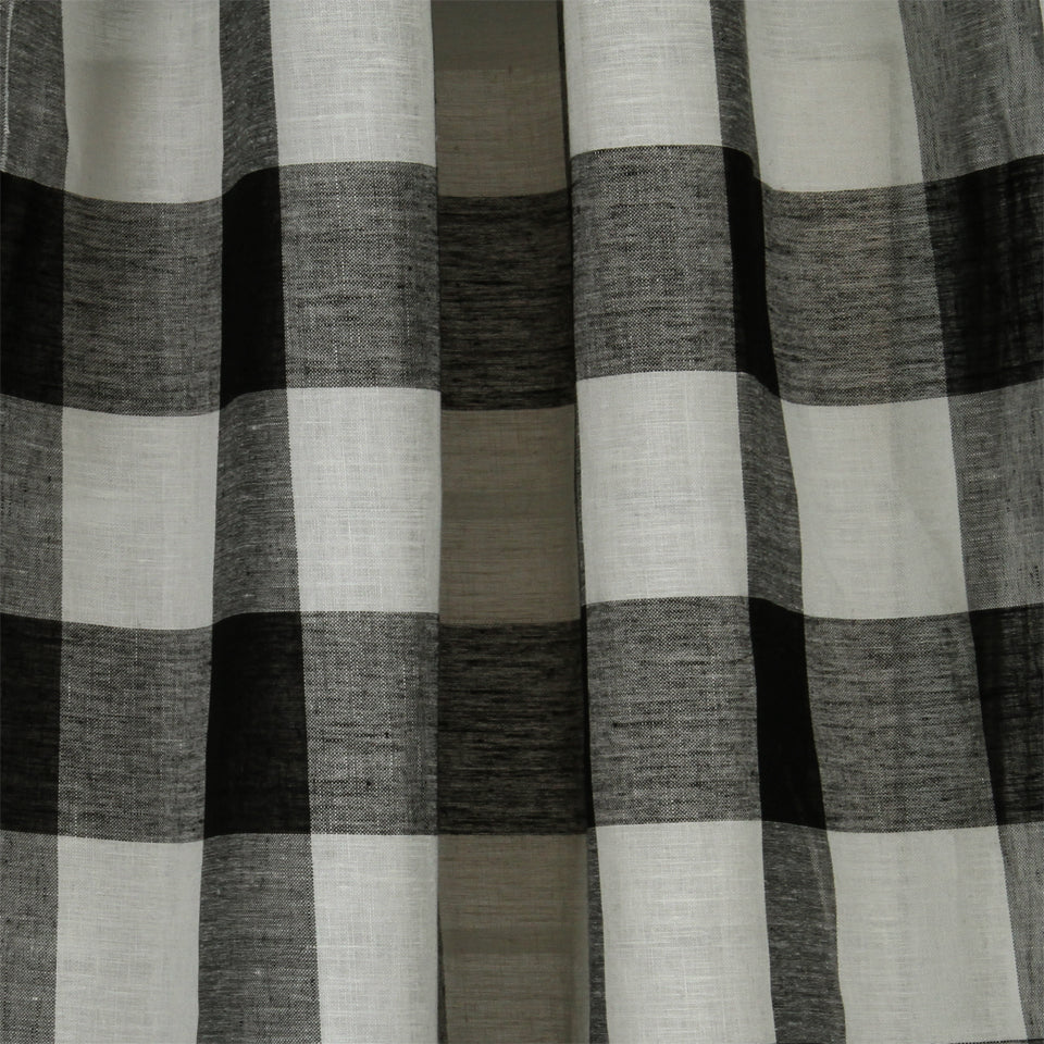 Gray, black, and white plaid curtain fabric with large checks and a soft, textured linen-like weave.