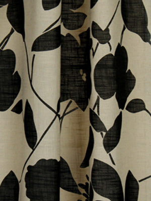 Beige linen-look curtain with bold black botanical leaf print and soft vertical folds