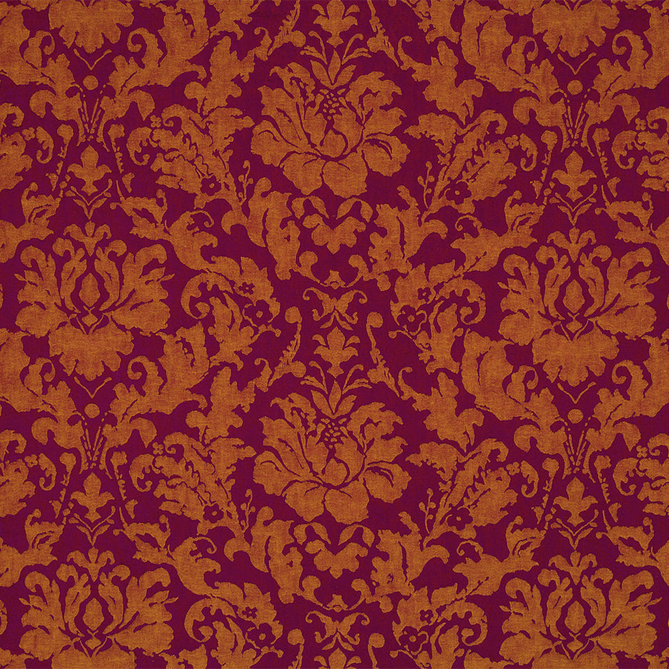 Damask floral pattern on magenta drapery fabric.