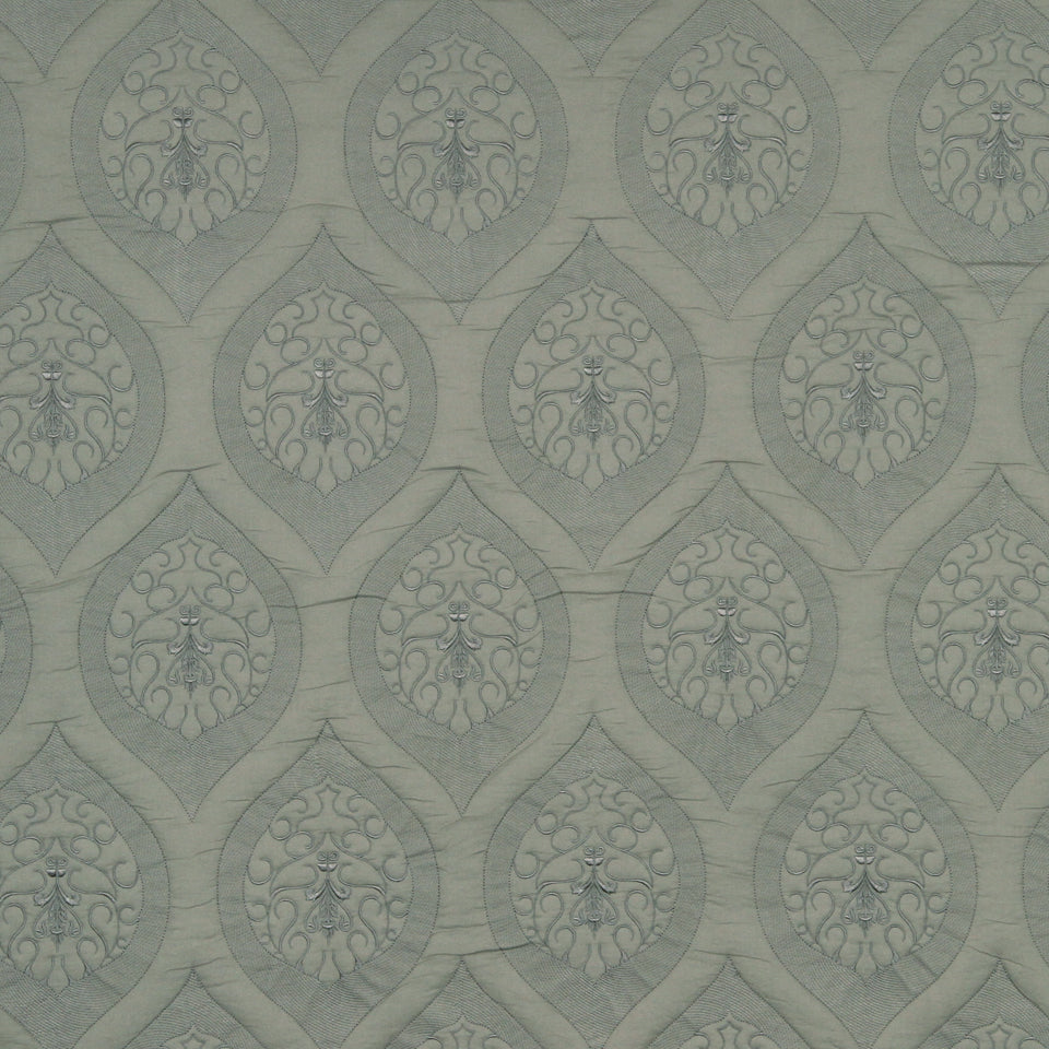 Muted sage-gray wallpaper with repeating teardrop-shaped arabesque medallions & delicate scrollwork.