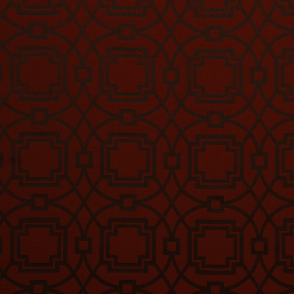 Saffron upholstery fabric with a repeating damask-style geometric lattice of interlocking squares and curved lines.